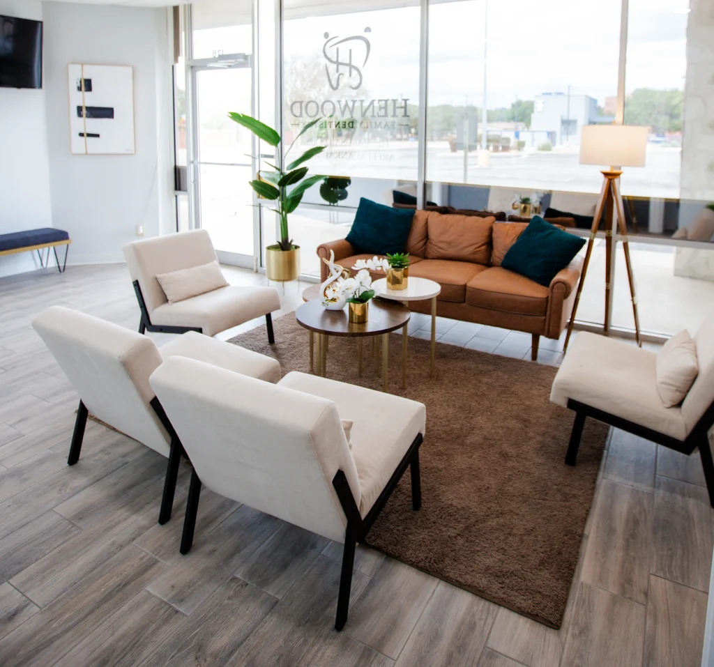 A modern living room with sleek couches and a futuristic coffee table equipped with integrated technology.