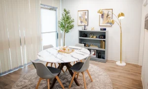 A technologically advanced room with a round table and chairs.