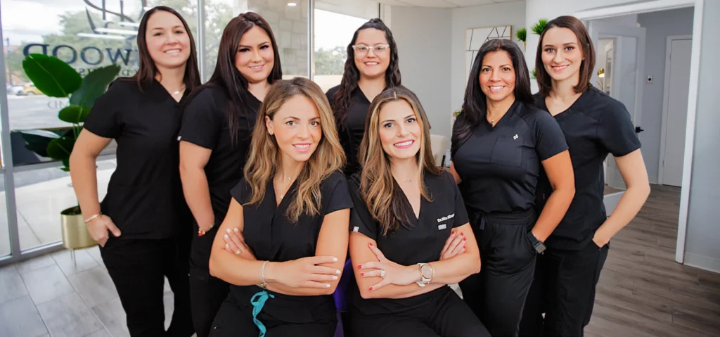 A group of female dentists posing for a photo at their workplace.