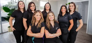 A group of female dentists posing for a photo at their workplace.