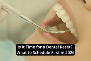 A dental mirror and tool are used to examine a person's teeth. Text overlay reads: "Is It Time for a Dental Reset? What to Include in Your Dental Schedule for 2026.