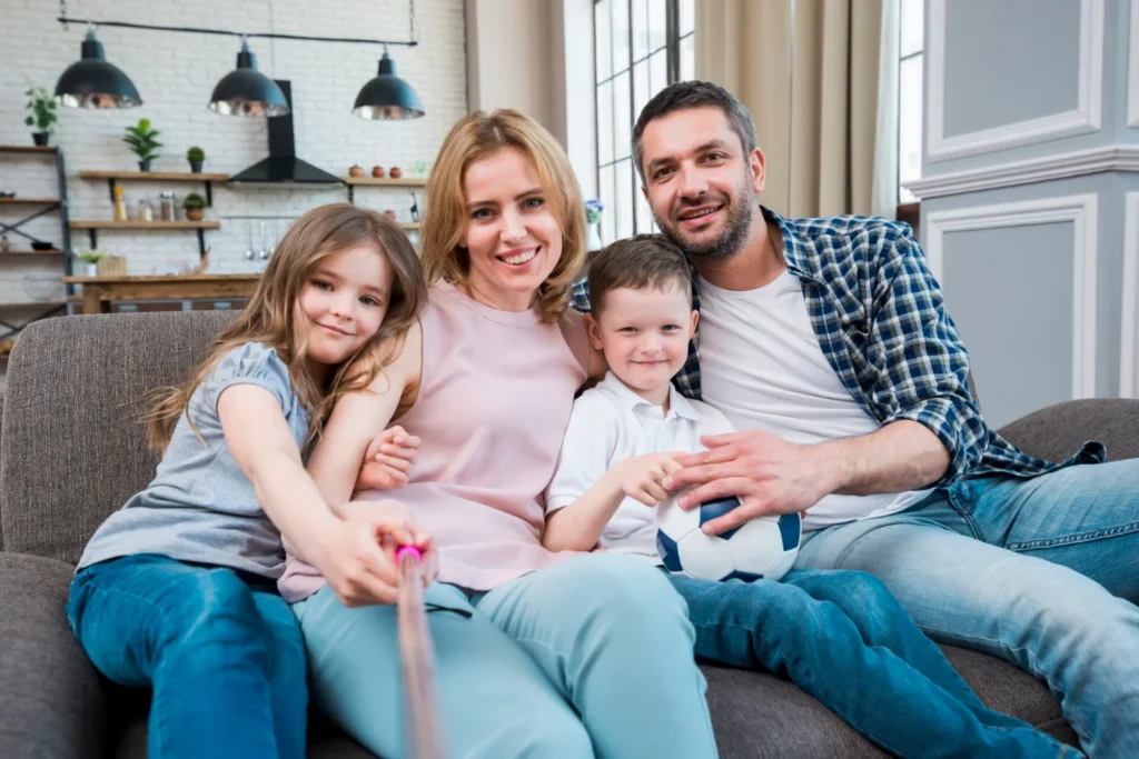 family of four sitting in the sofa